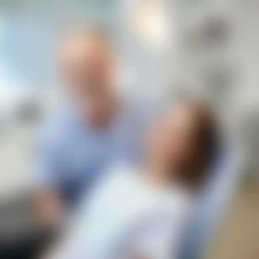 Family dentist providing dental care to an older adult